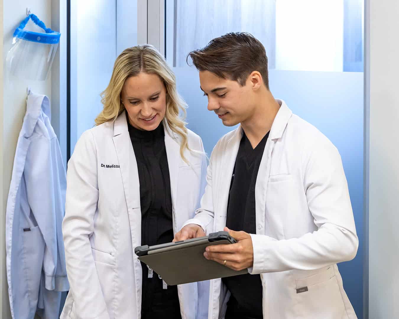 Dr. Smith and Dr. Aschinger Looking At Tablet